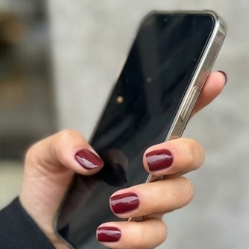 Hand wearing dafies press-on nails