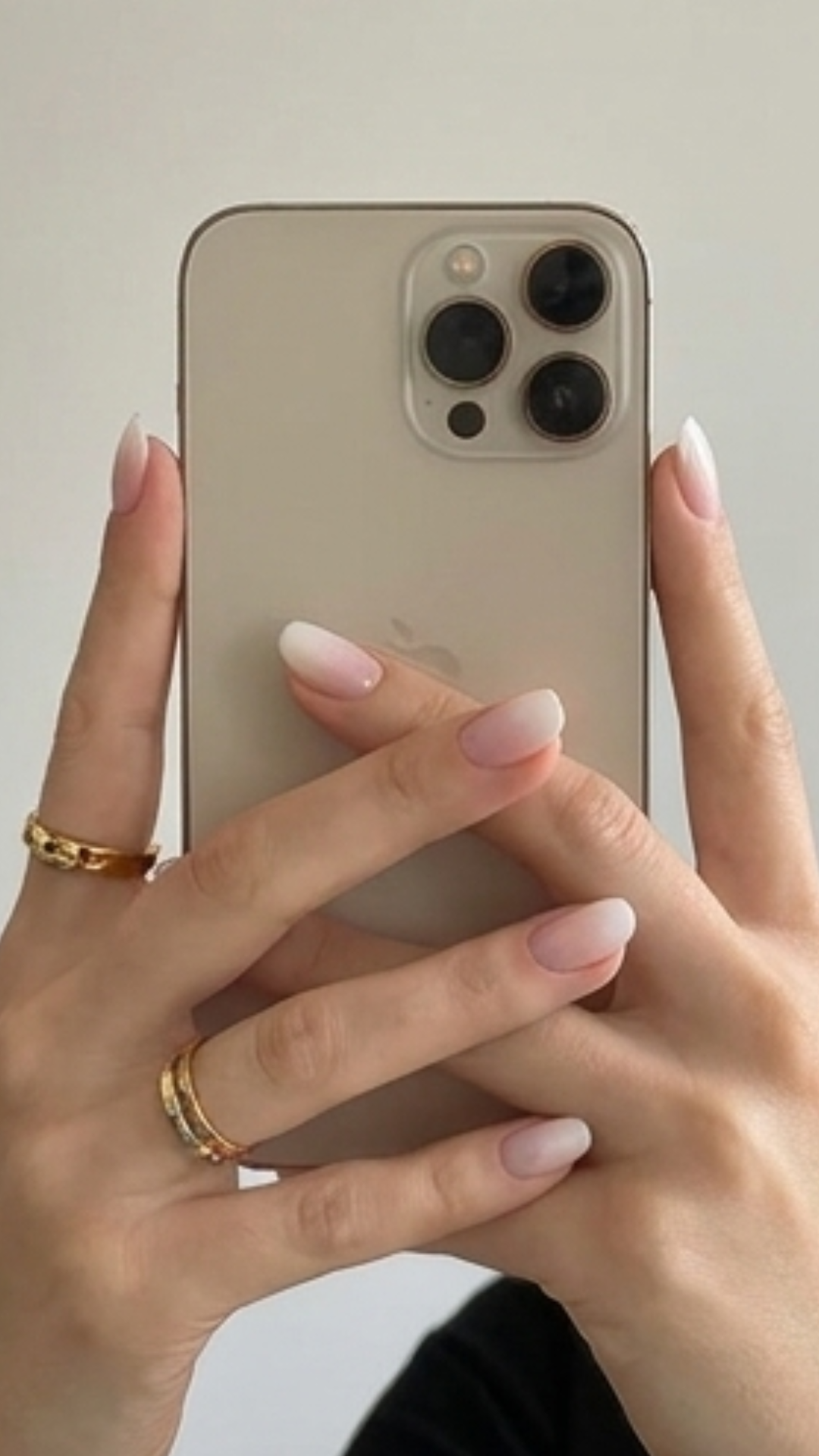 Hands holding a phone, wearing soft French ombre press-on nails